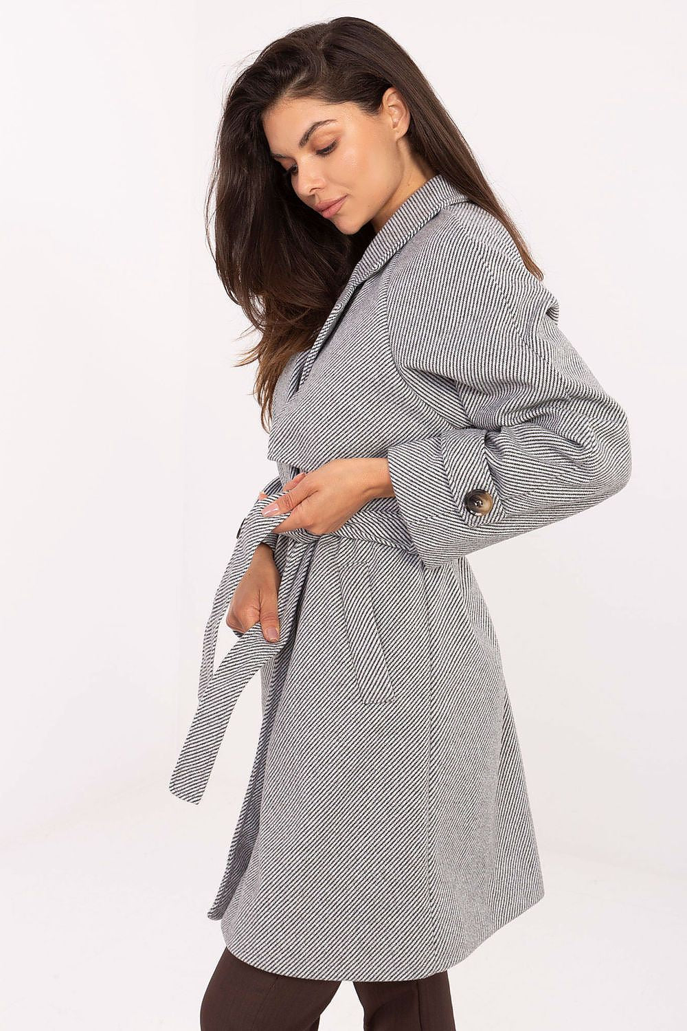 Side view of Elara Women’s coat showing inset pockets and subtle strap detail on sleeve, versatile knee-length coat for spring and autumn.”