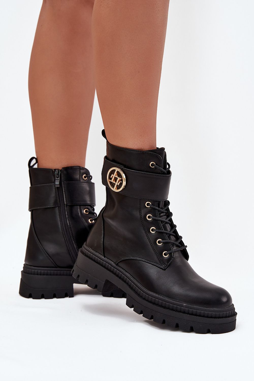 Side angle of eco-leather ankle boots showing gold strap detail and zipper.