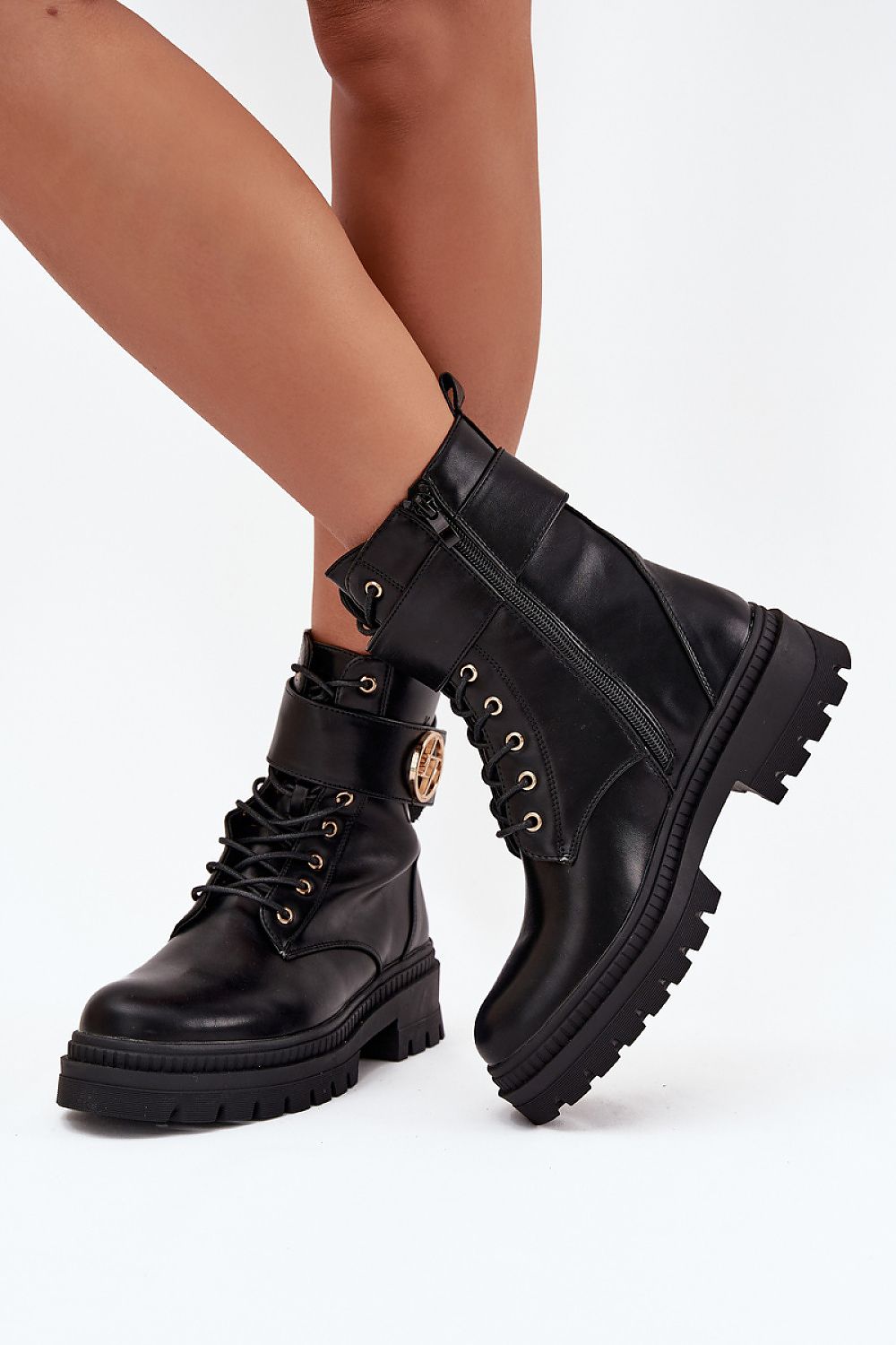 Front view of women’s eco-leather ankle boots with fur lining and laces.
