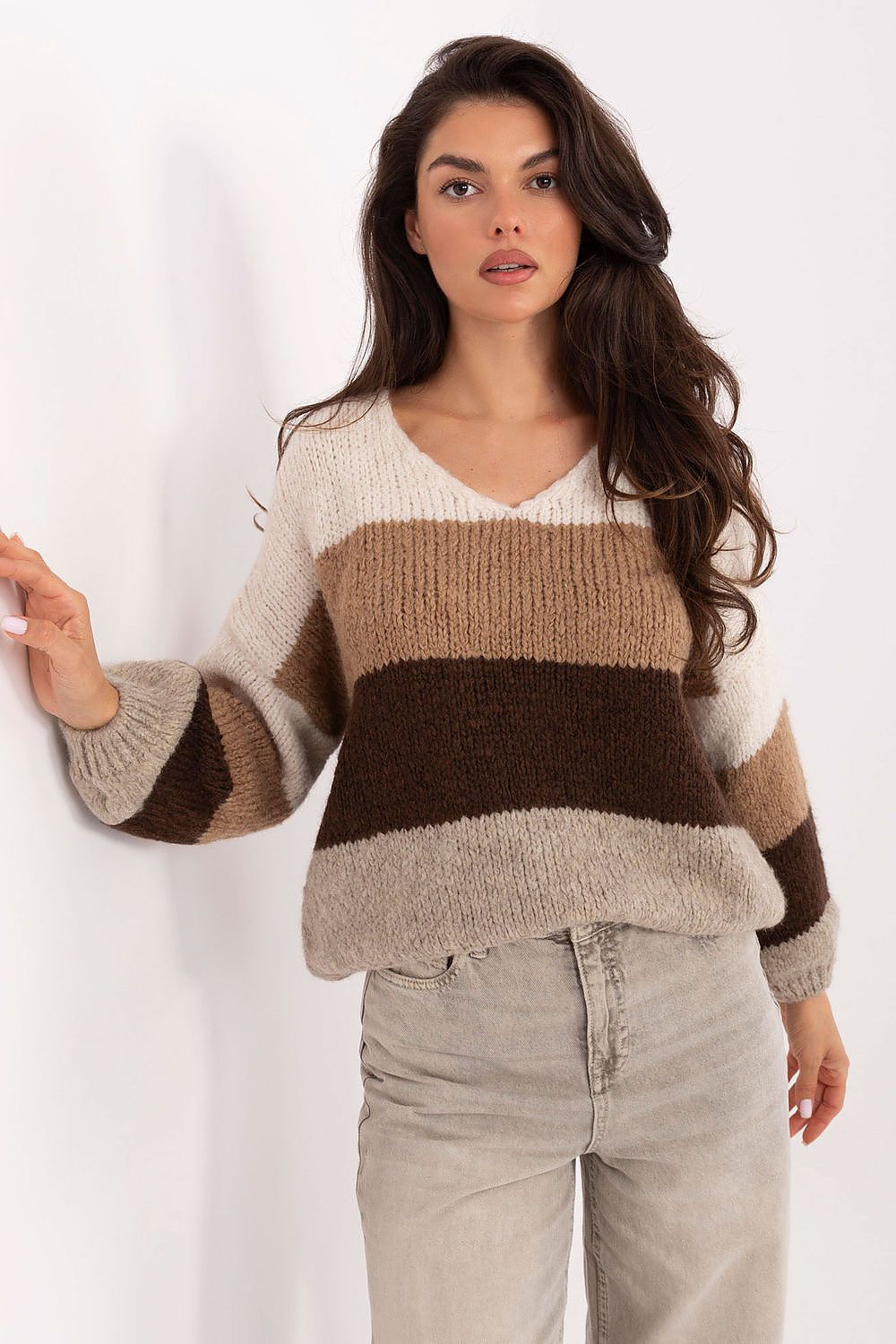 Beige and black oversized striped sweater with V-neckline – front view.