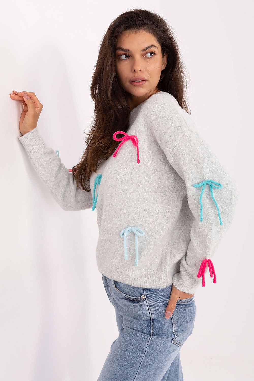 Grey sweater styled with trousers, lifestyle image.