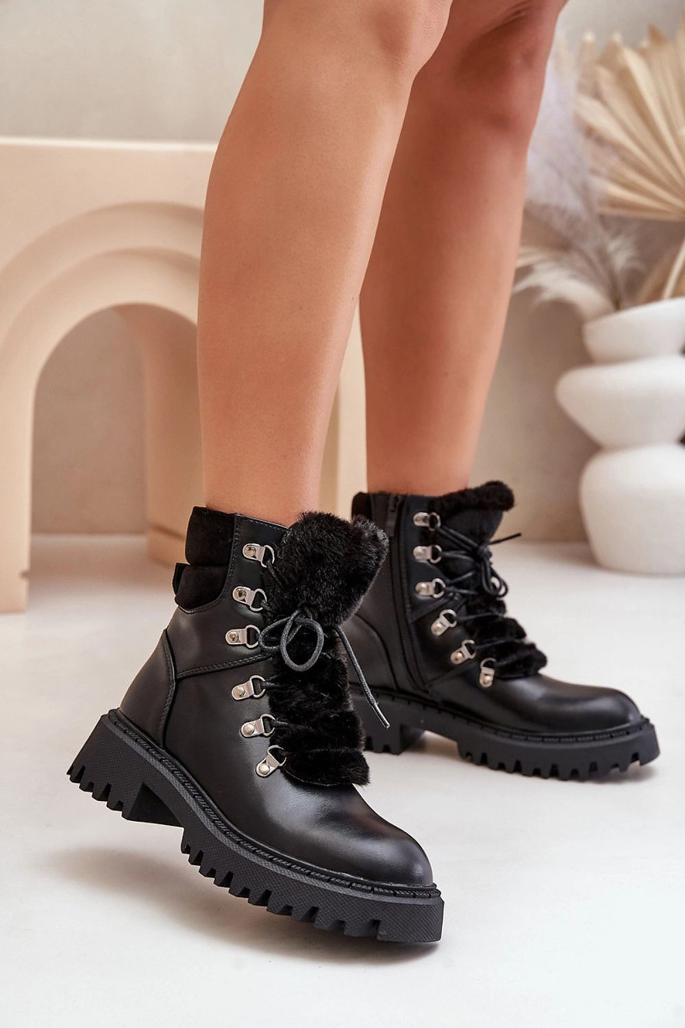 Side view of black eco leather ankle boots with zipper and laces