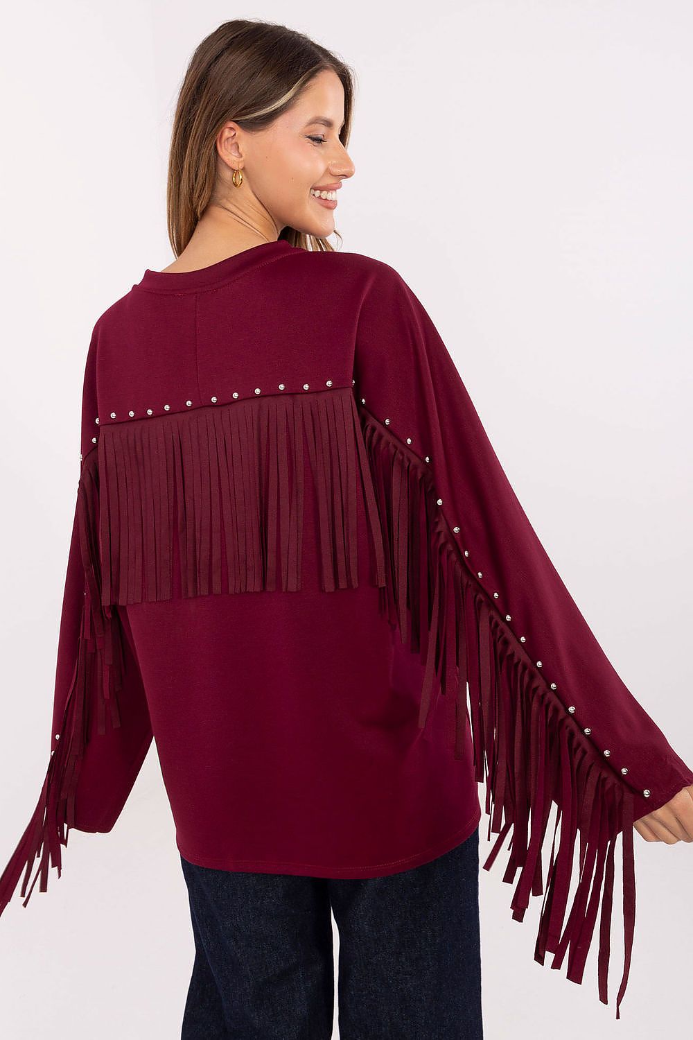 Back view of red sweatshirt showcasing dynamic fringes and stud accents