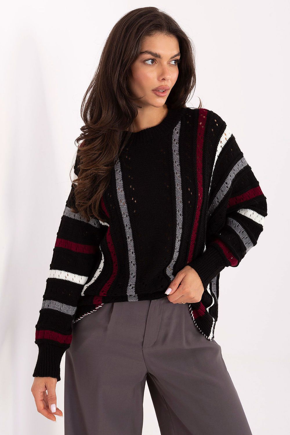 Black oversized women’s sweater with openwork stripes and round neck.