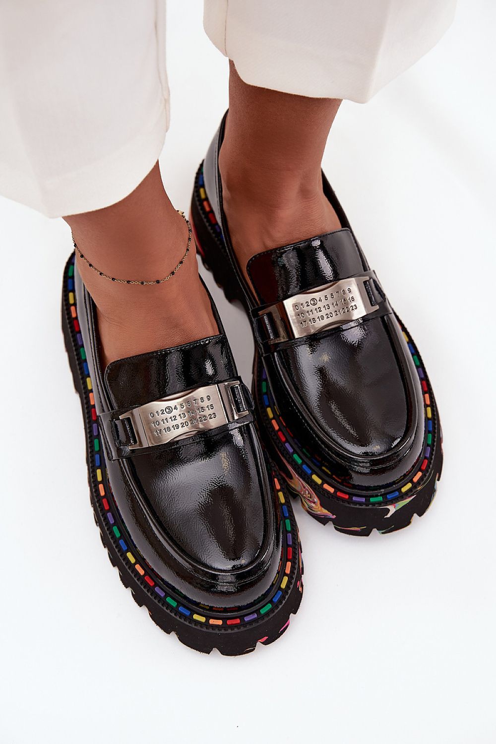  Front view of Artiker women’s patent leather moccasins with decorative plate detail