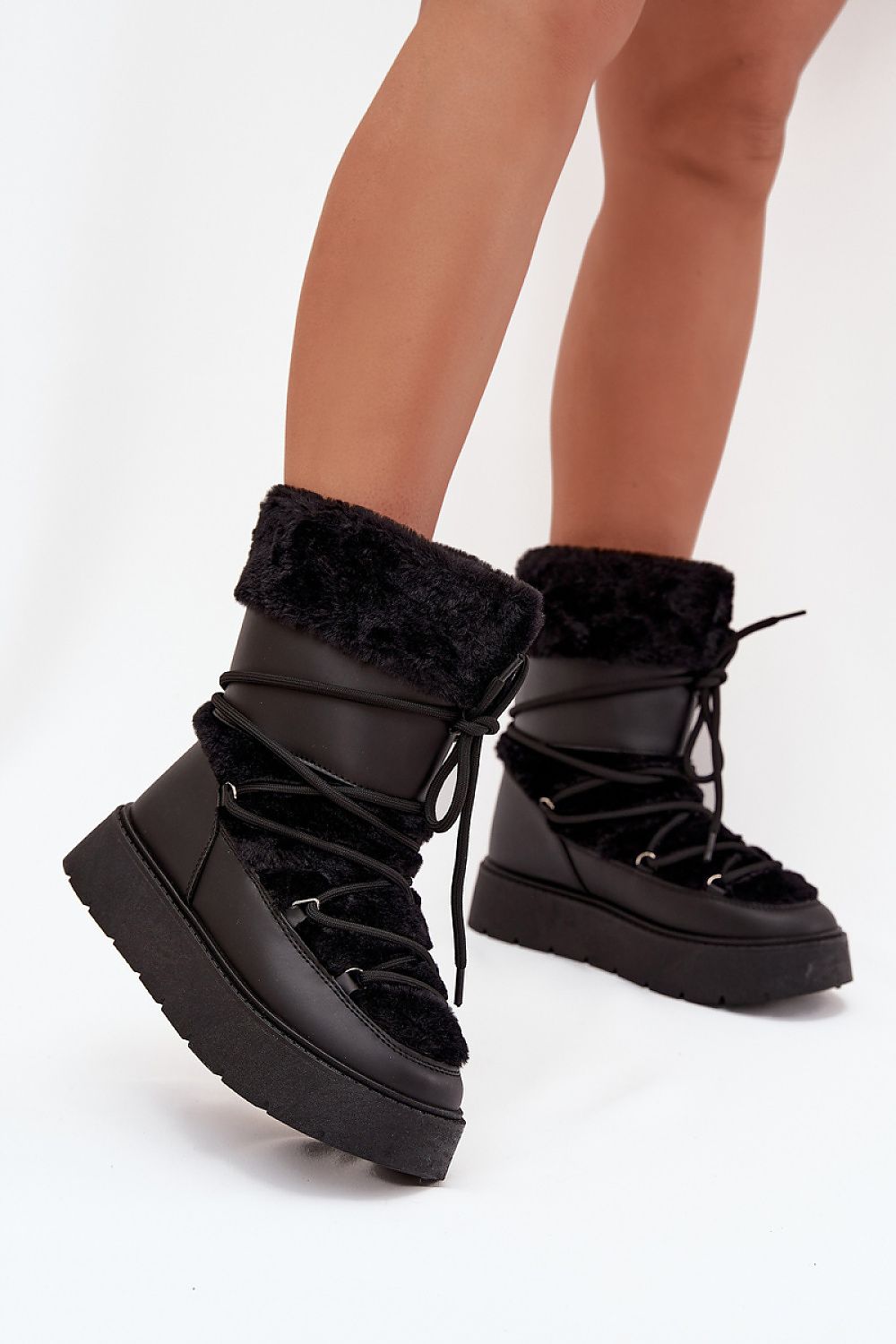 Front view of black women’s platform snow boots with fur lining and laces