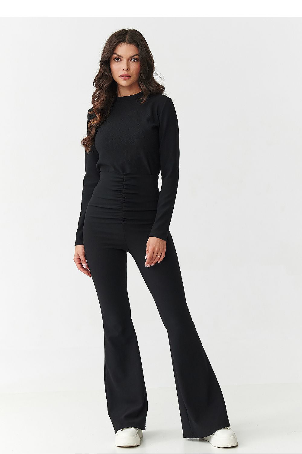 Woman wearing a black outfit on a white background