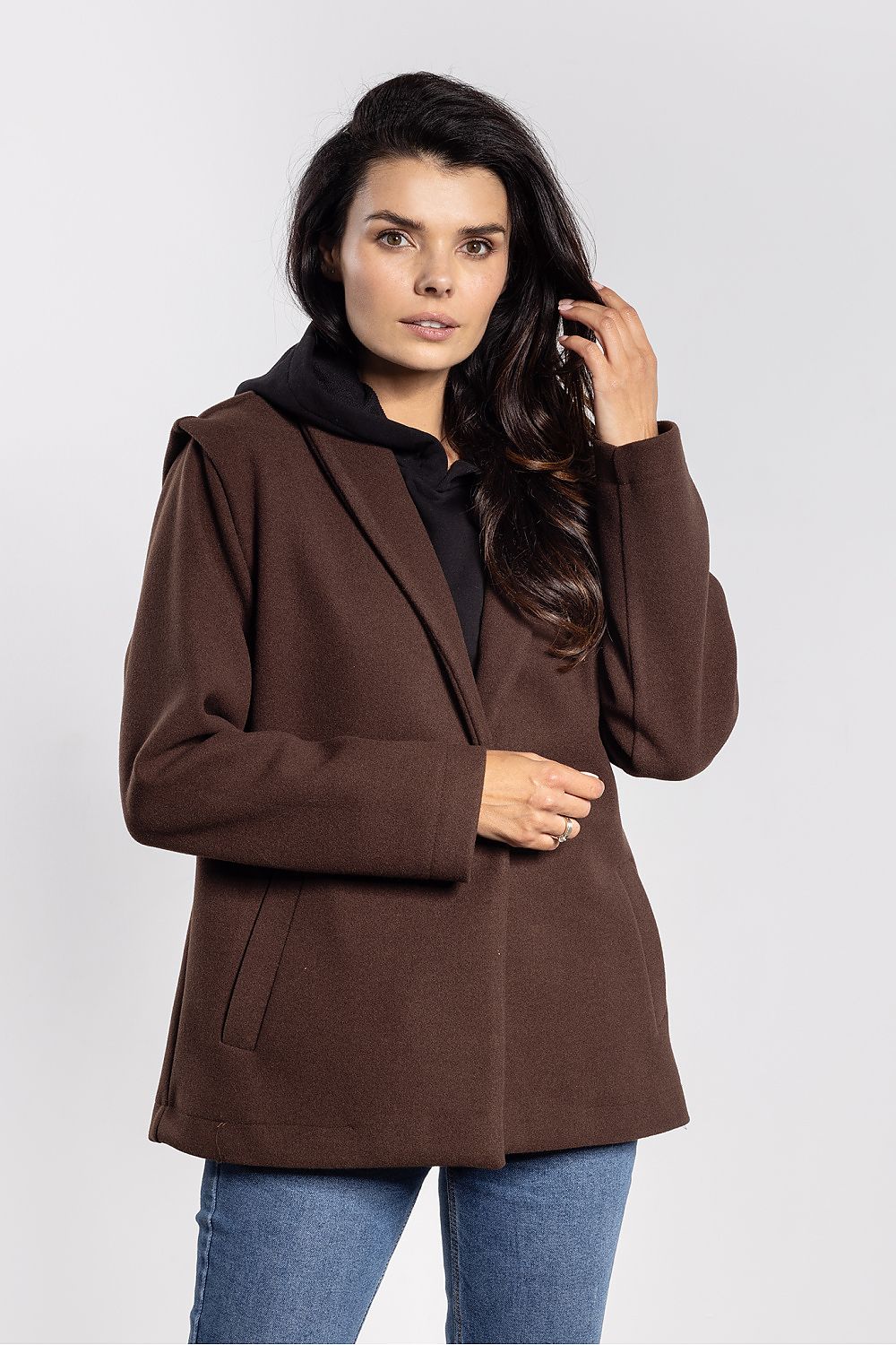 Woman wearing a brown coat on a white background