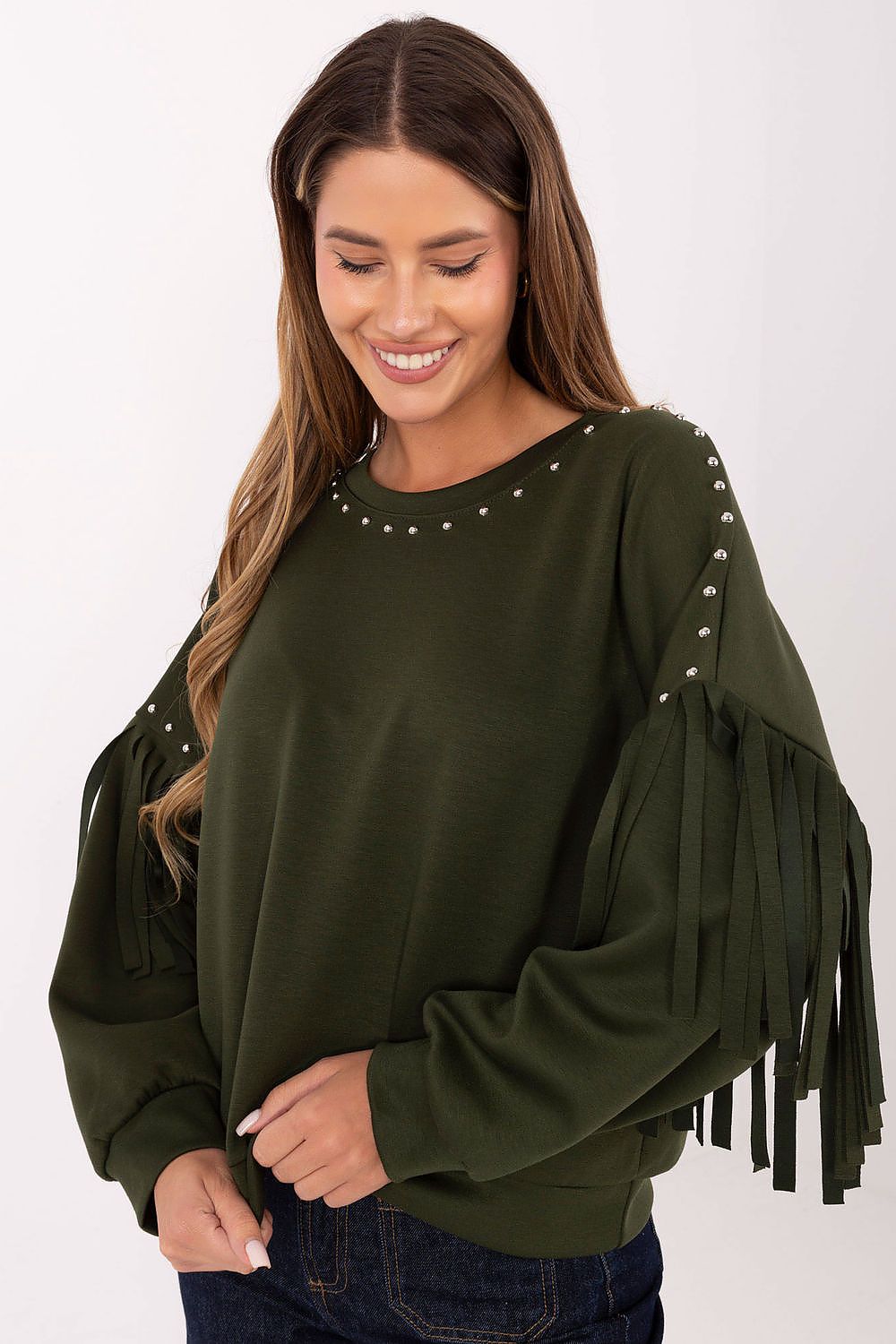 Model wearing studded fringe sweatshirt front view – Woman in a smooth casual sweatshirt with a studded neckline and fringe-detailed sleeves.