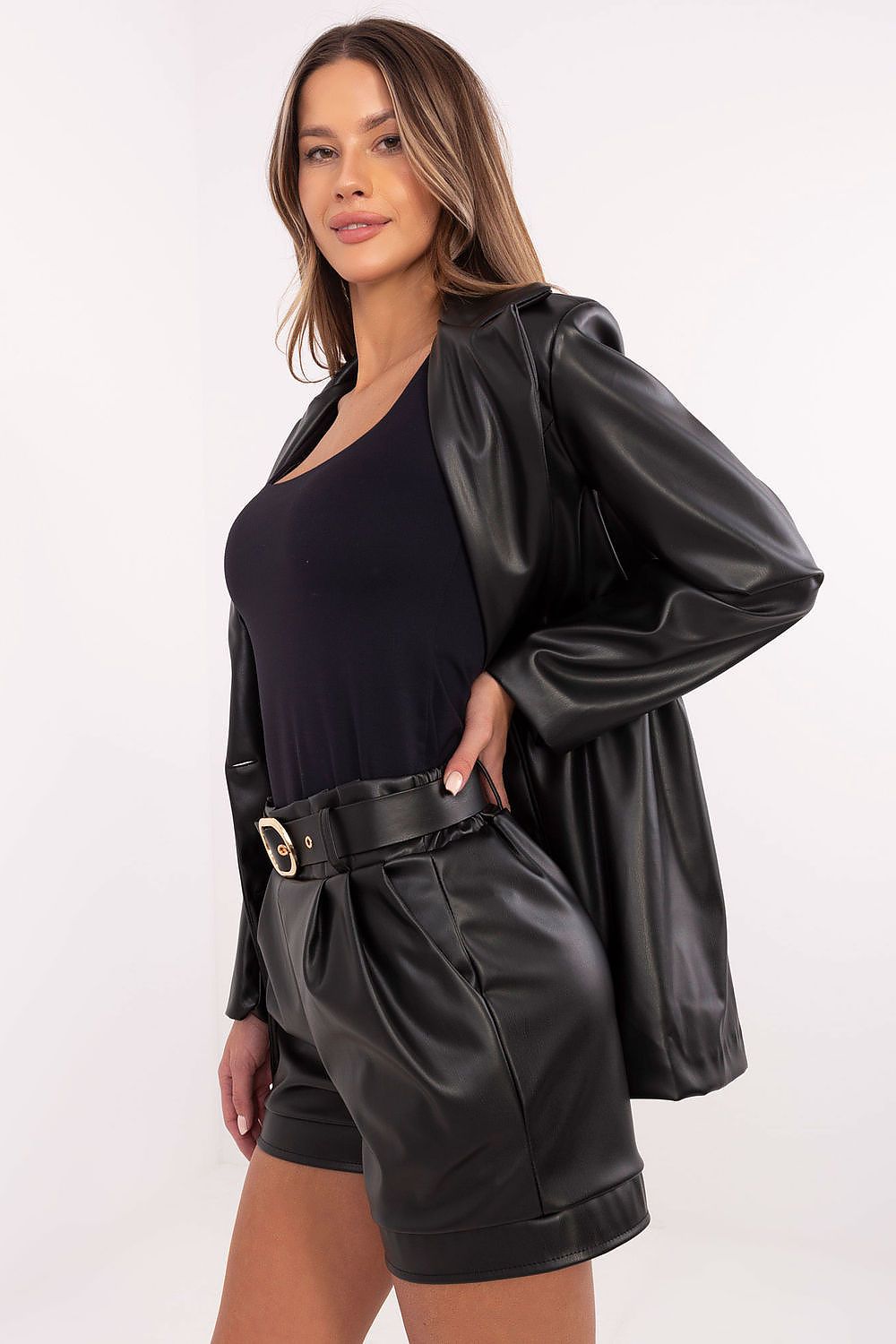  Side view – Stylish eco leather shorts showing smooth texture and practical side pocket detail.