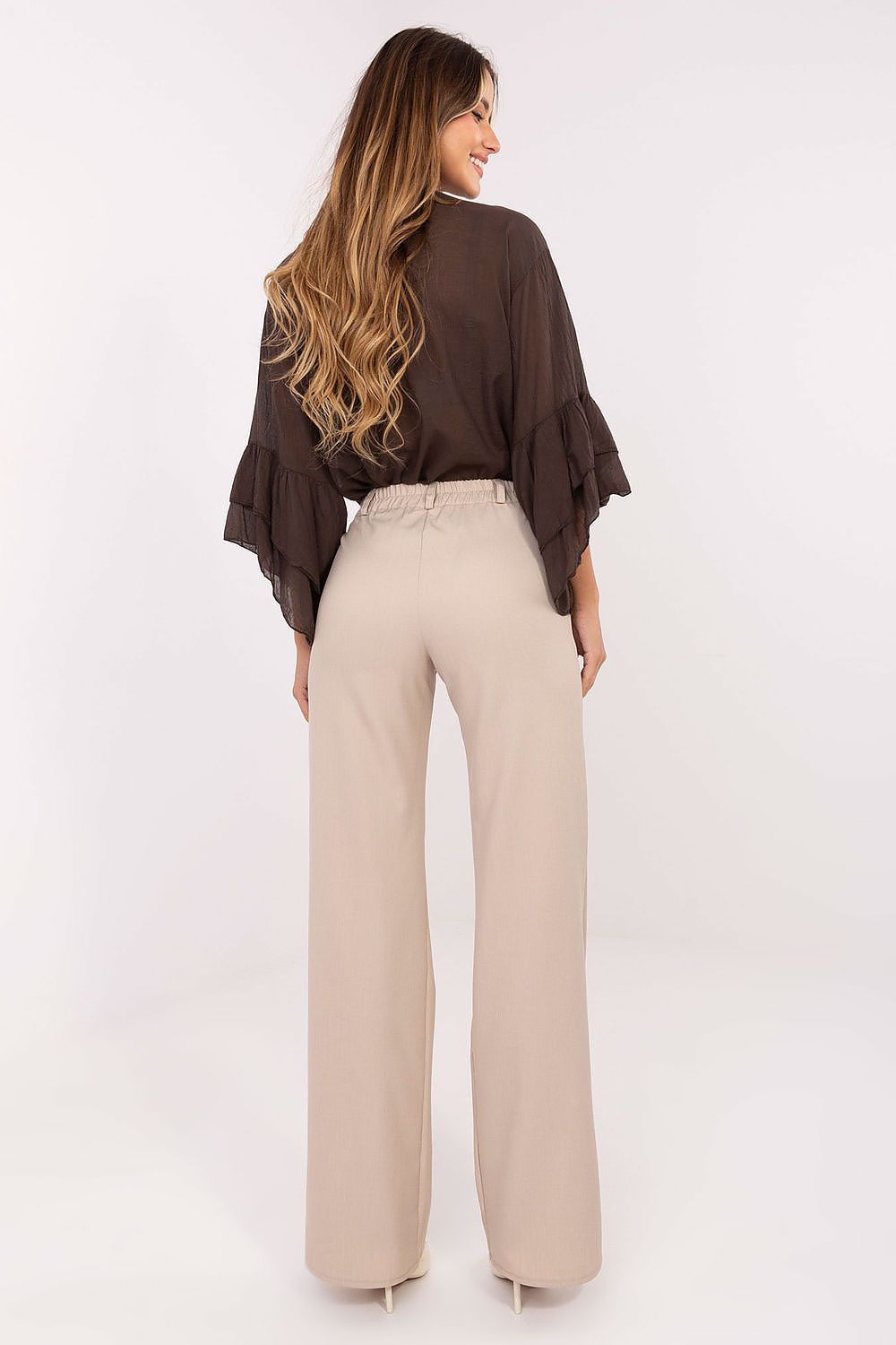 Detail of waistband and smooth fabric of women's trousers