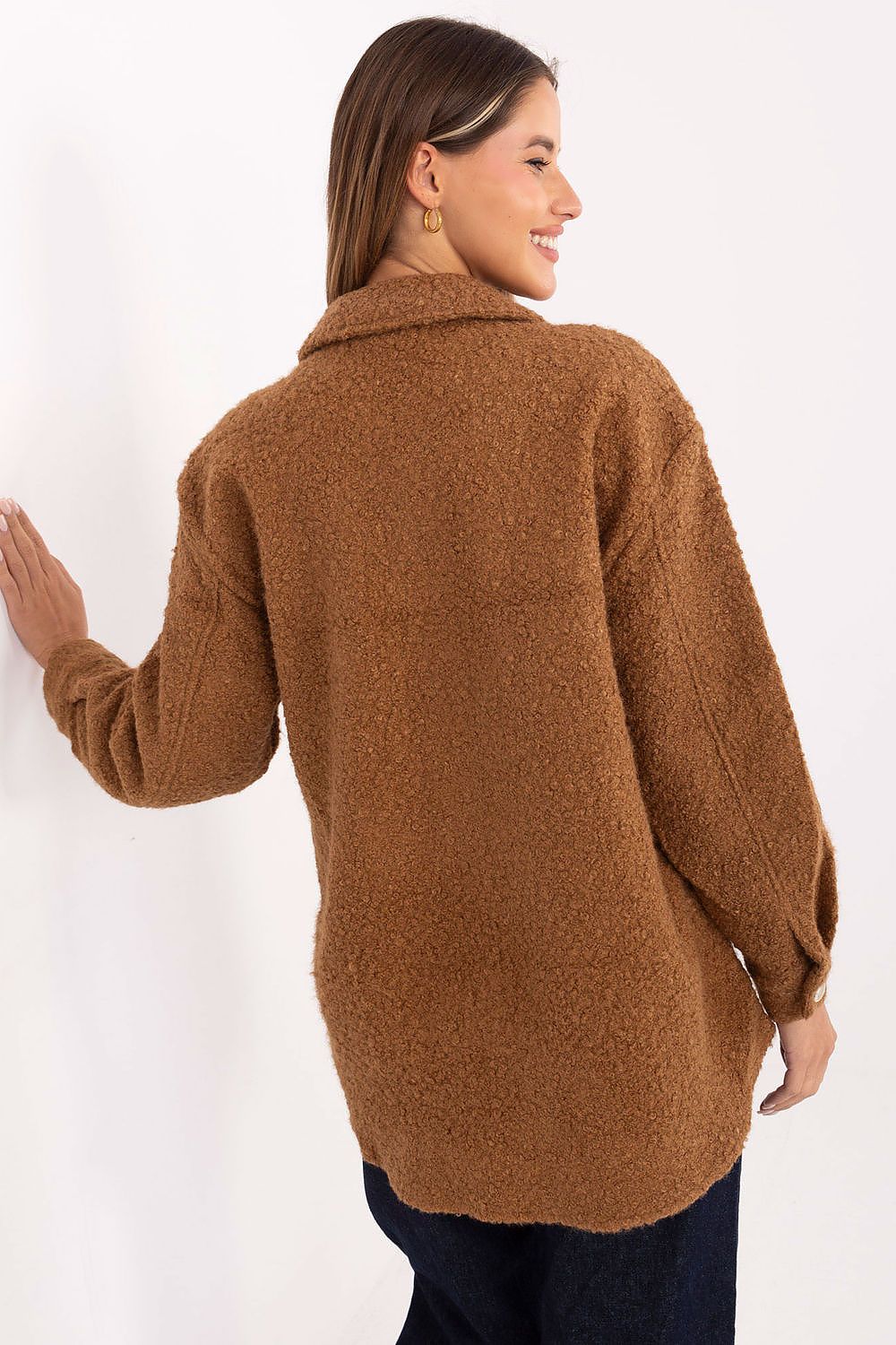  Detailed view of brown bouclé shirt texture and flap pocket.