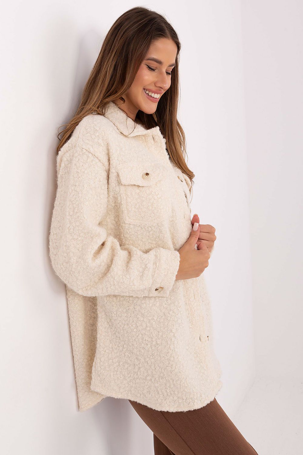 Beige textured bouclé shirt styled casually with jeans, side view.