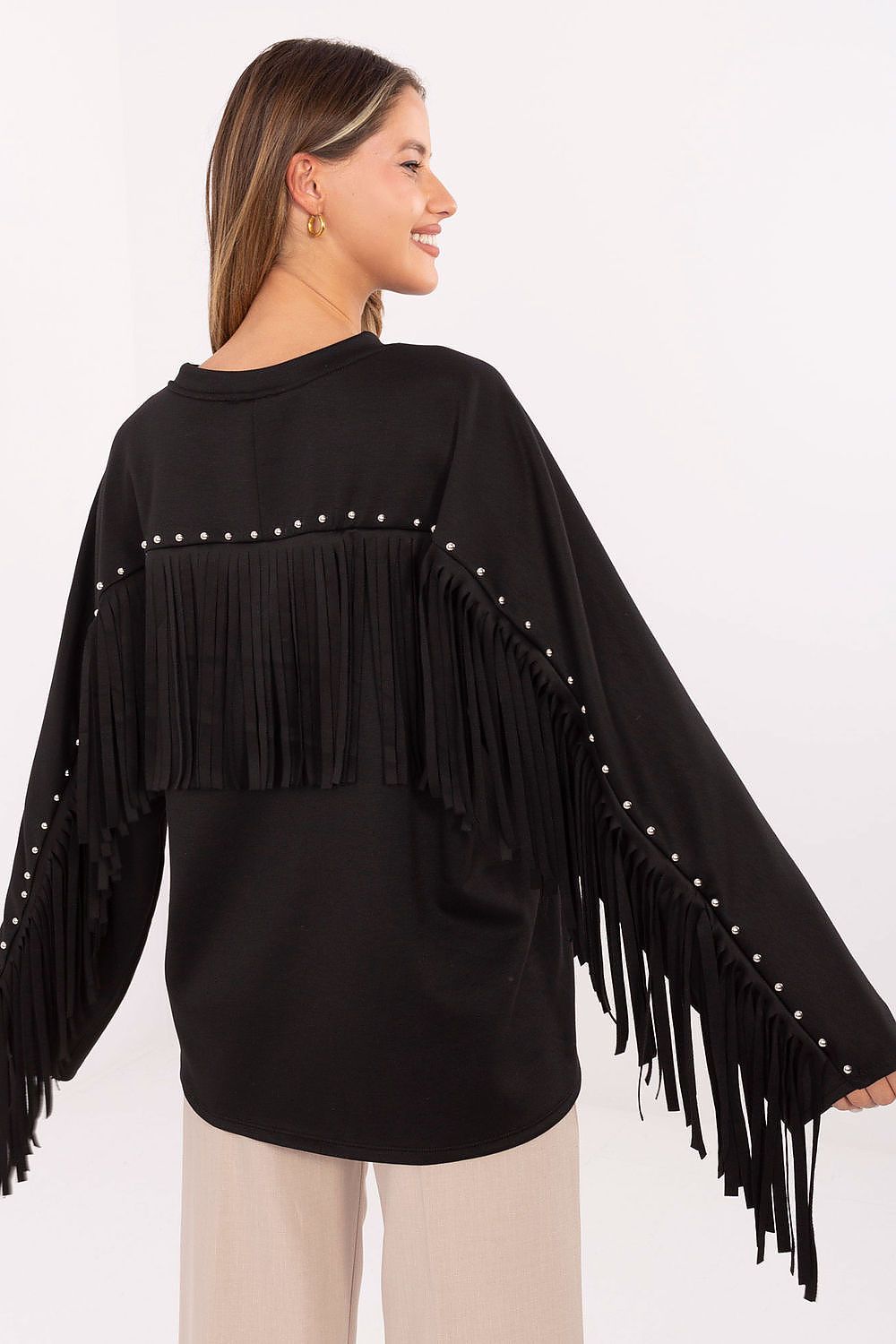 Detail shot of black sweatshirt’s stud and fringe embellishments