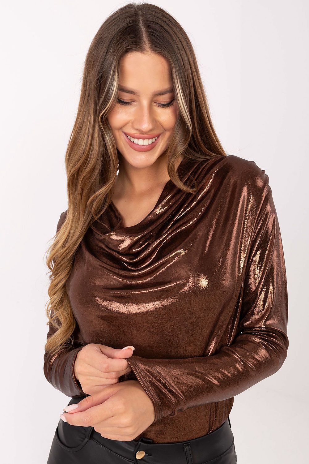 Close-up of pleated texture and flowing neckline of the blouse in brown
