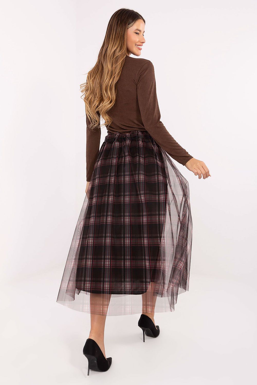 Close-up of checkered pattern and delicate tulle overlay on elegant midi skirt in black