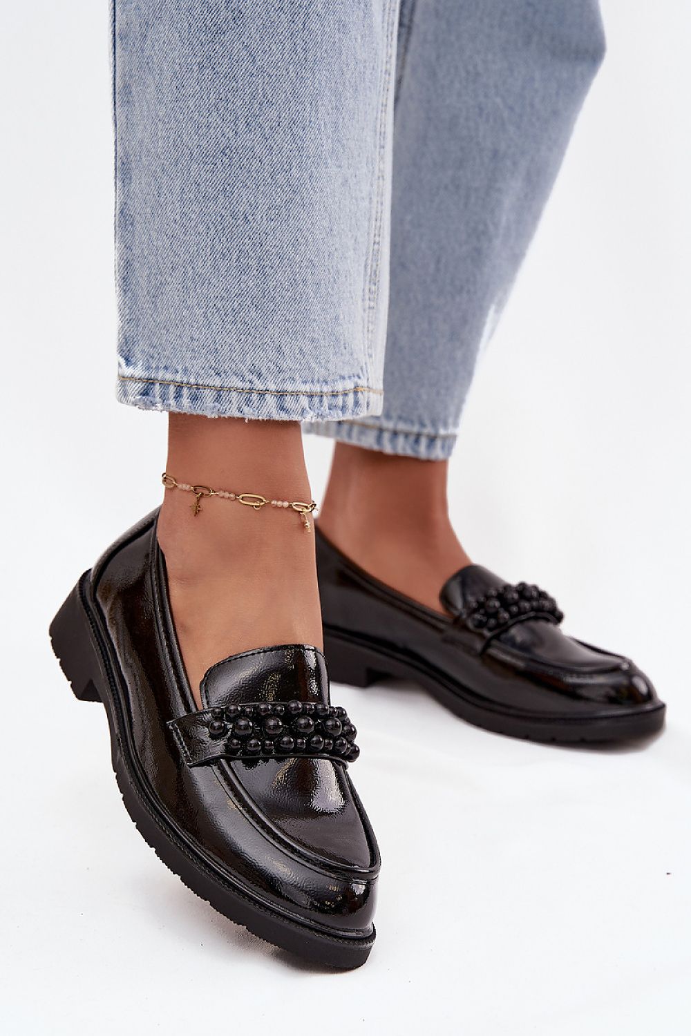 Side view of shiny eco leather loafers with rounded toes.