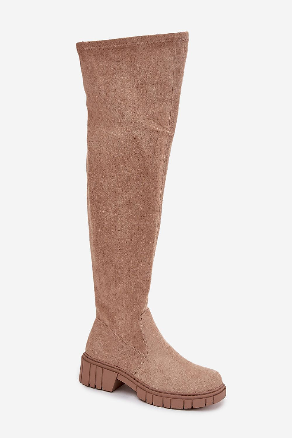 Angled view of the tall boots styled with a skirt, showcasing their elegant winter look.