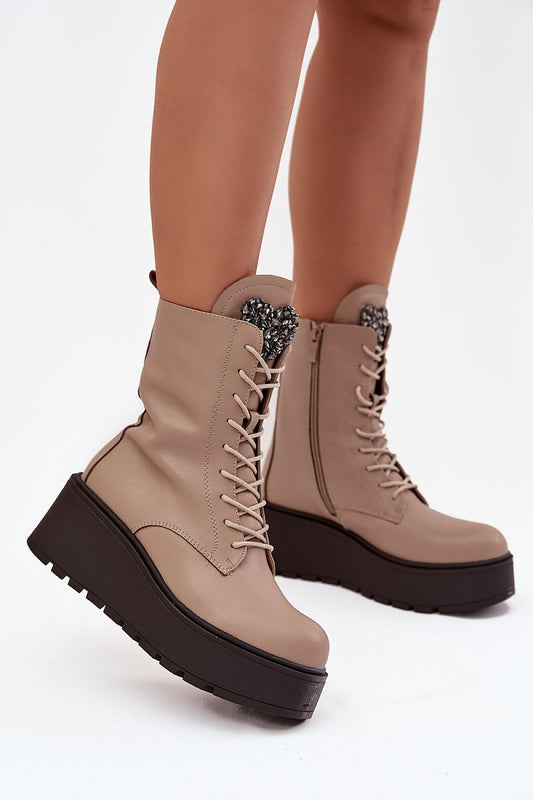 Side view of Jezzi ankle boots showing wedge heel, zipper, and smooth leather texture.