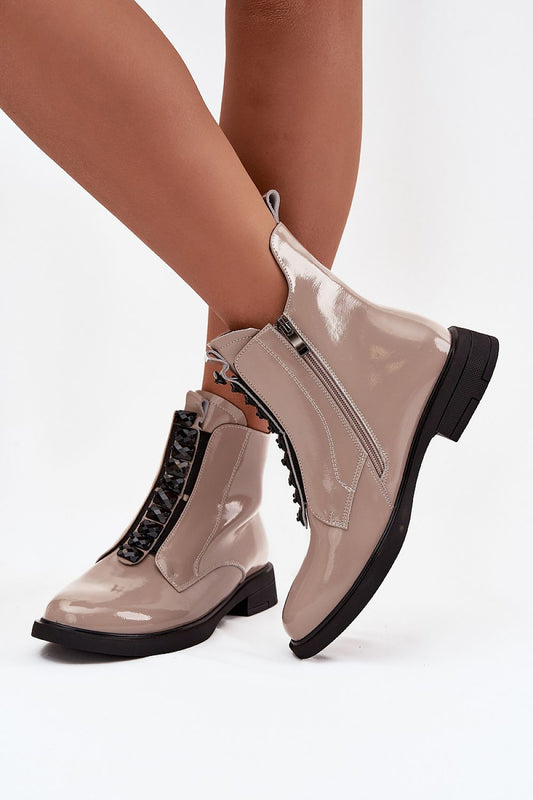 Side view of shiny patent leather ankle boots with zipper fastening.