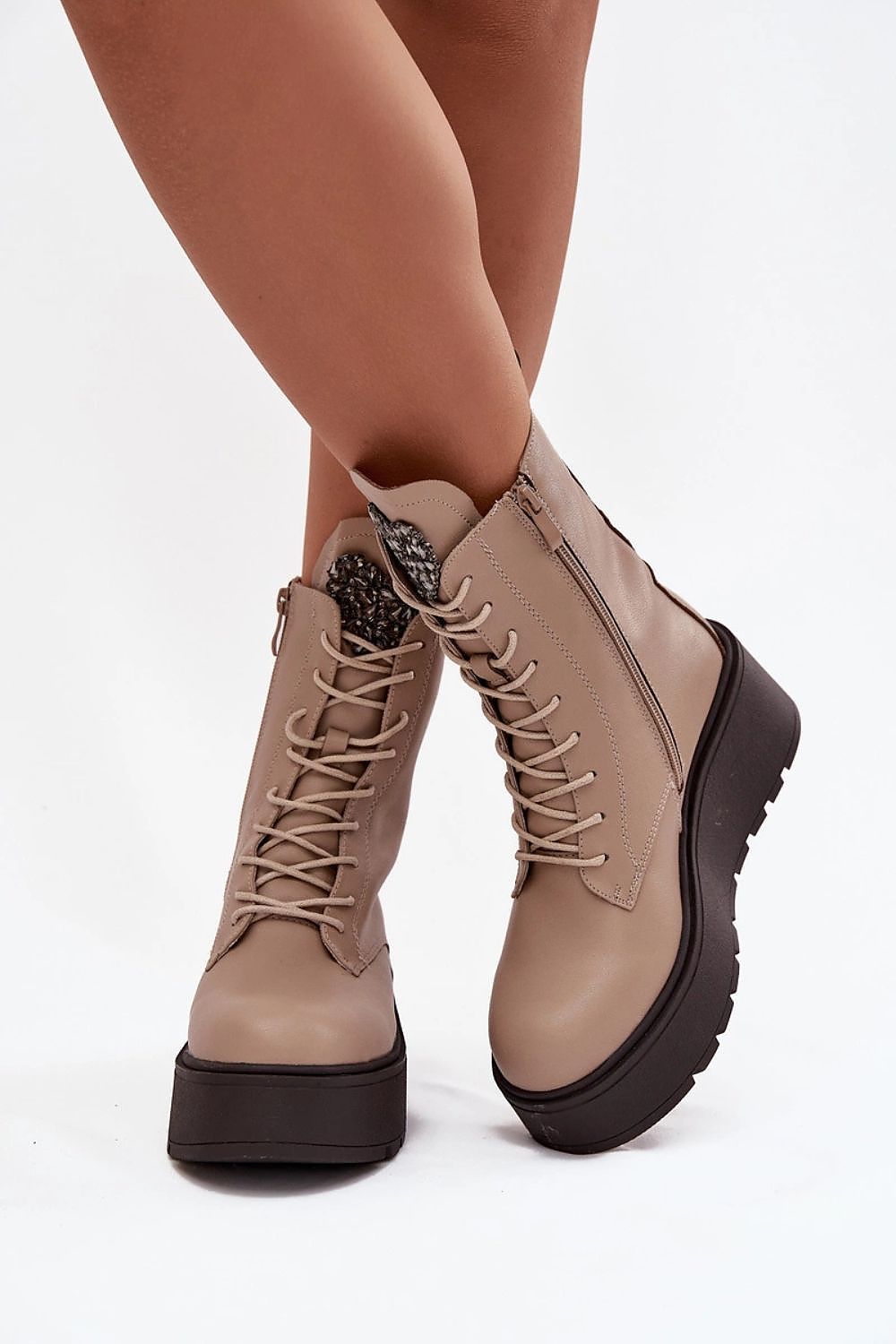 Front view of natural leather wedge ankle boots with heart-shaped crystal detail on the tongue.