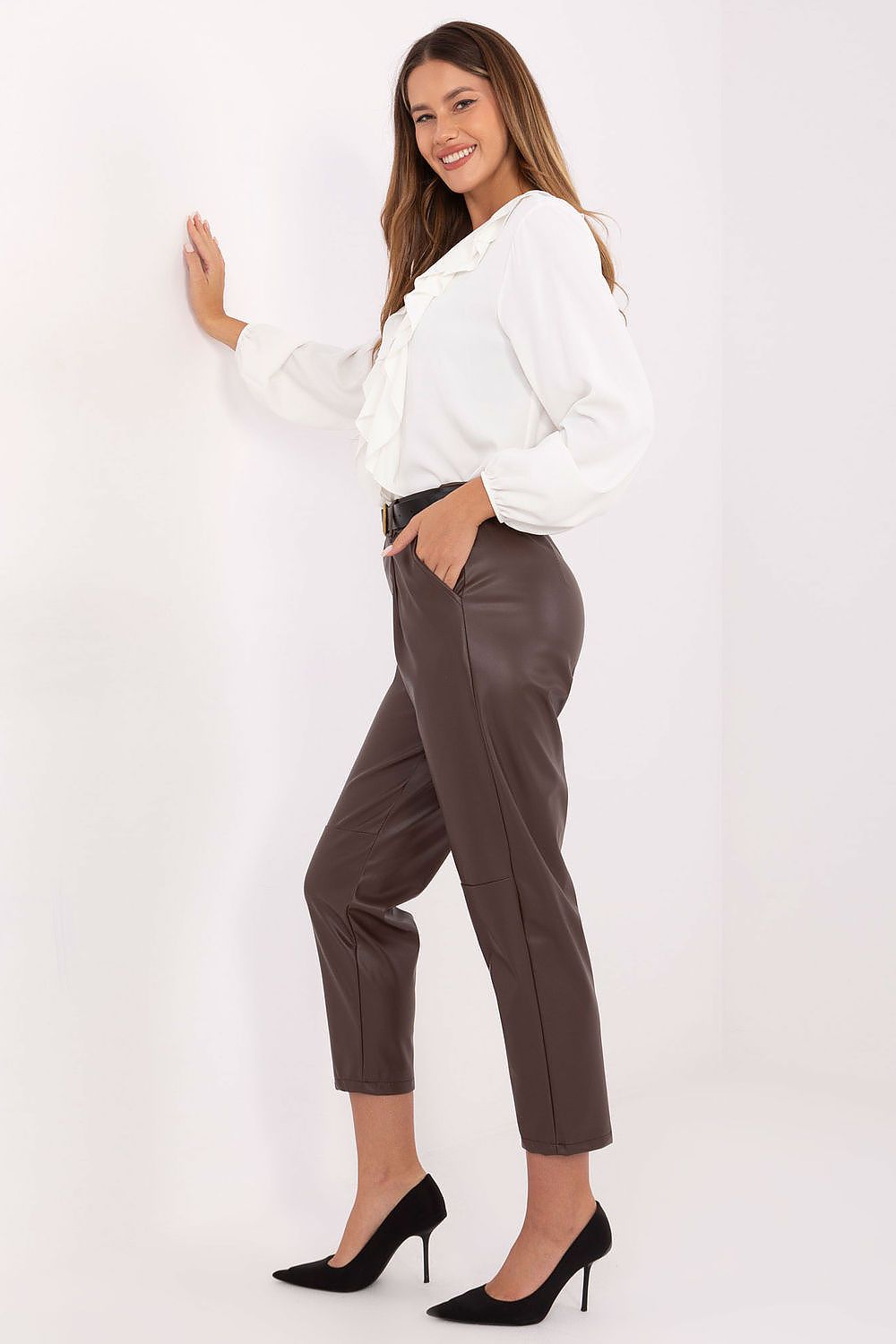 Brown high-waisted faux leather trousers highlighting smooth finish – side view.