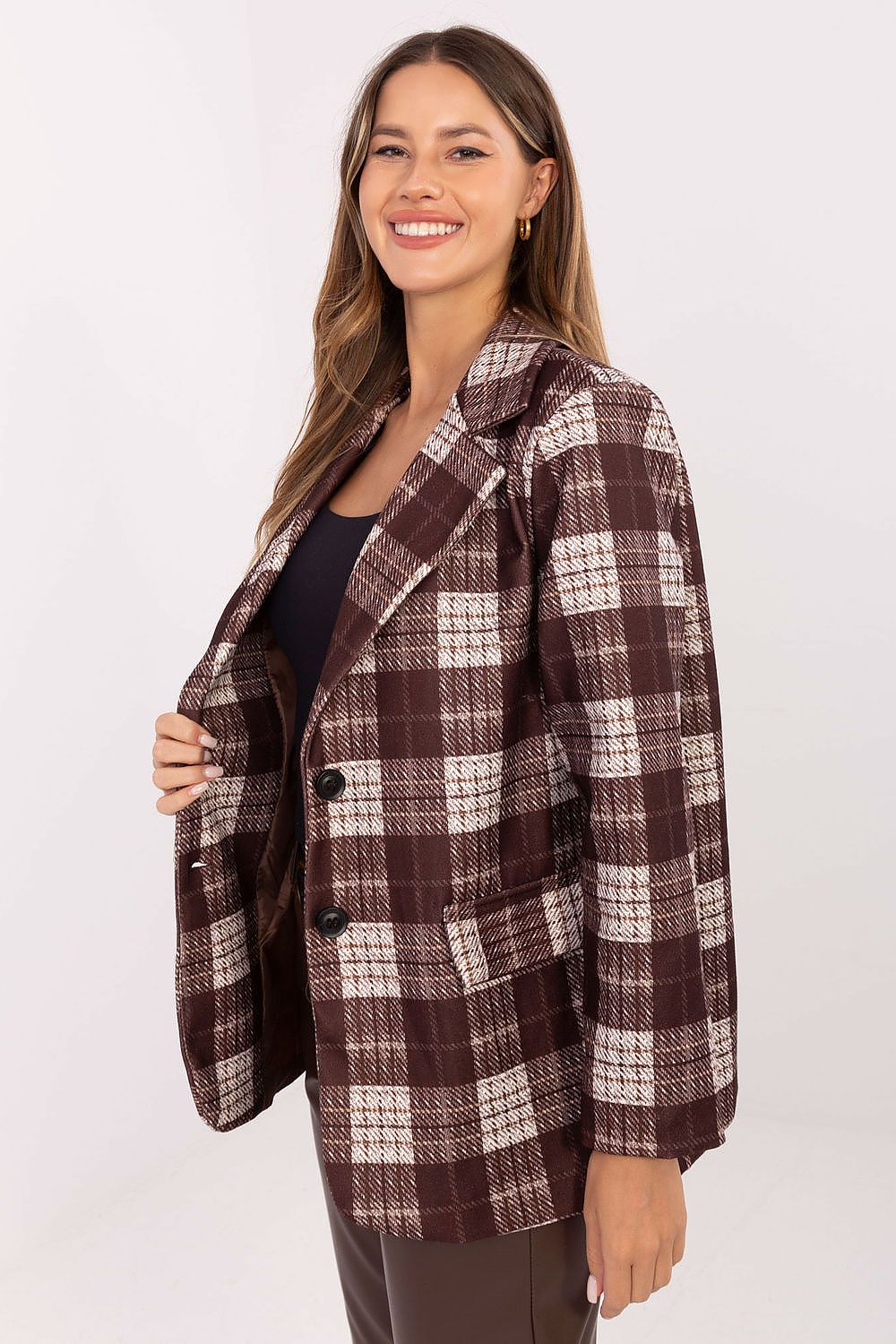 Side view of the checkered blazer highlighting structured shoulders and fitted silhouette in brown