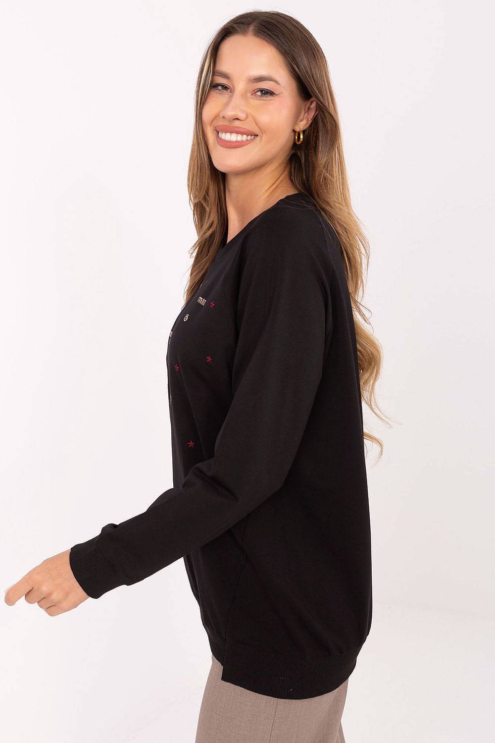 Woman wearing a black long-sleeve top on a white background