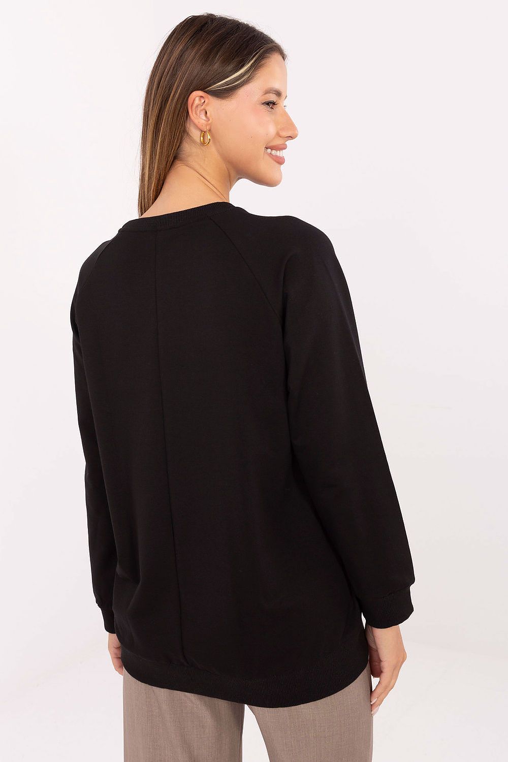 Woman wearing a black sweater on a white background