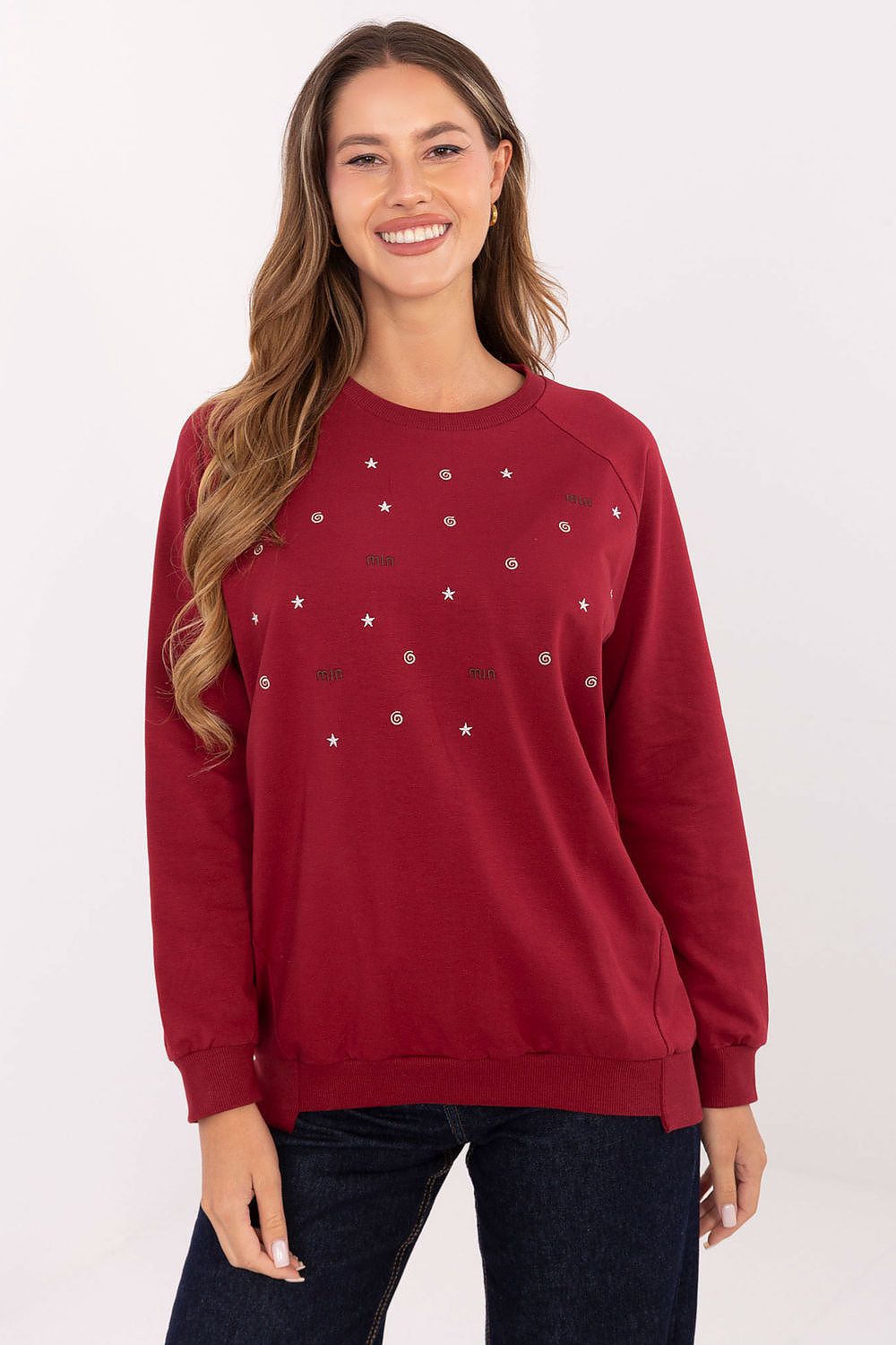 Woman wearing a red sweater with star patterns on a white background