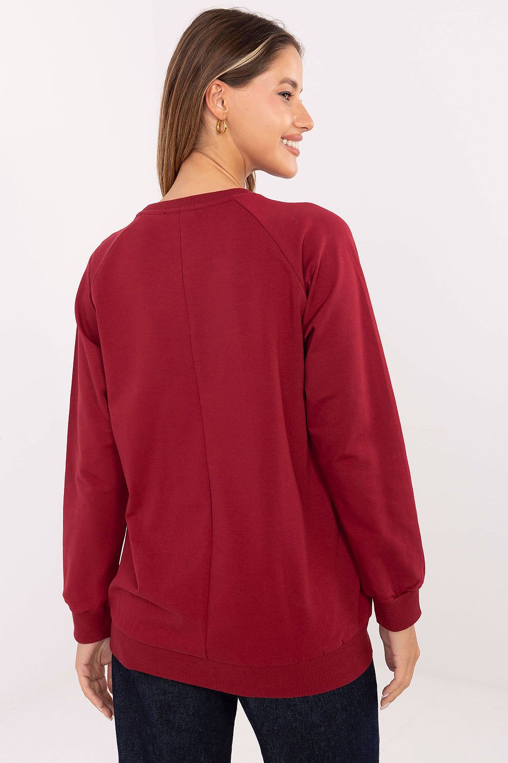Woman wearing a red sweatshirt on a white background