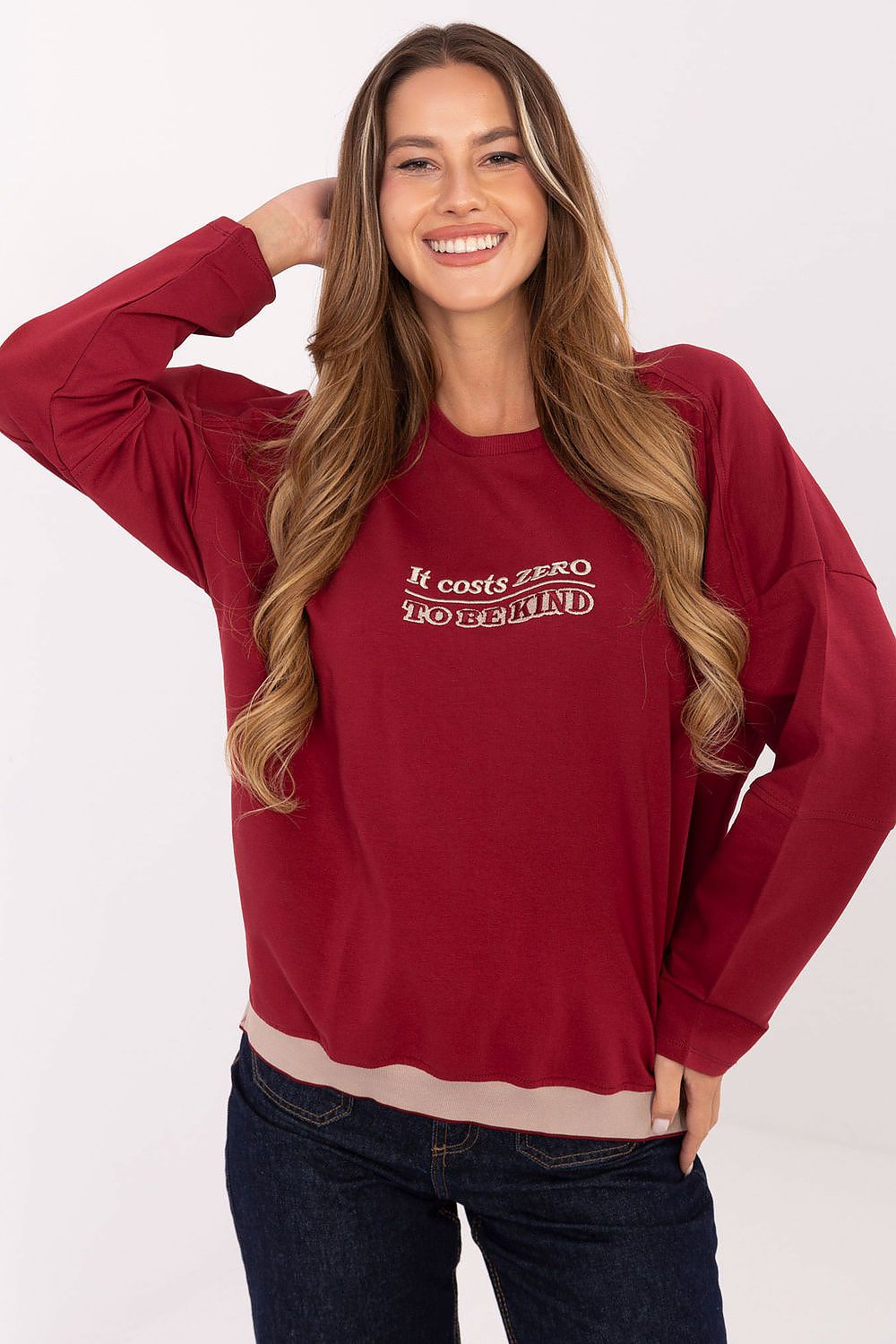 Woman wearing a red sweatshirt with text on a white background