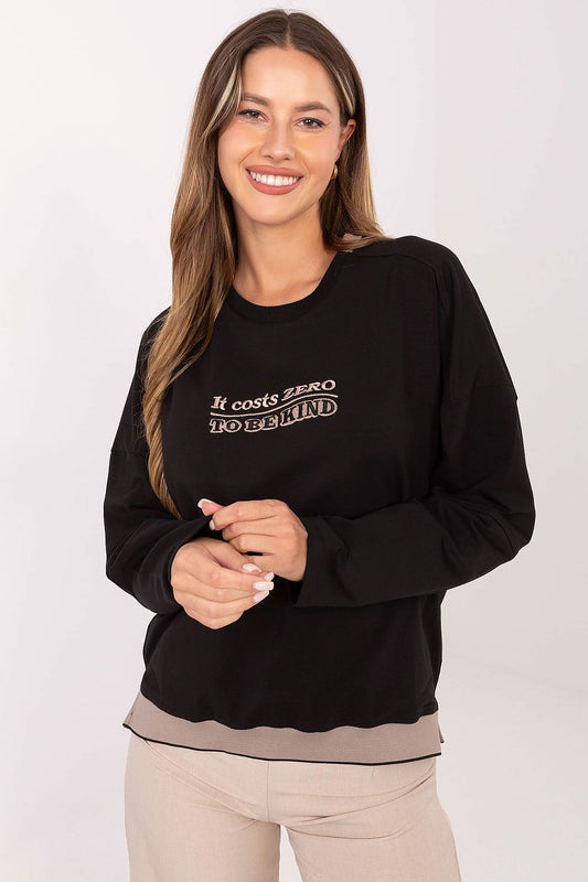 Woman wearing a black sweatshirt with text on a white background