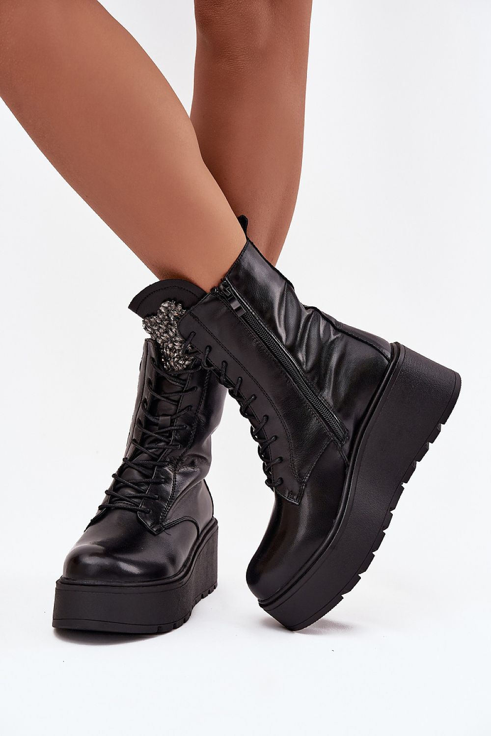 Side view of black natural leather wedge boots showing wedge and zipper
