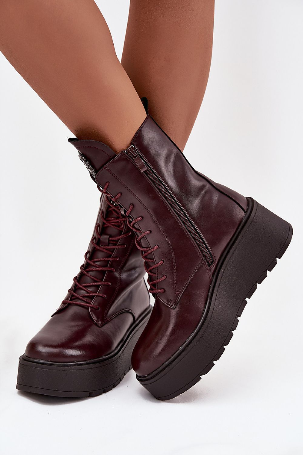 Side view of red natural leather wedge boots showing wedge and zipper