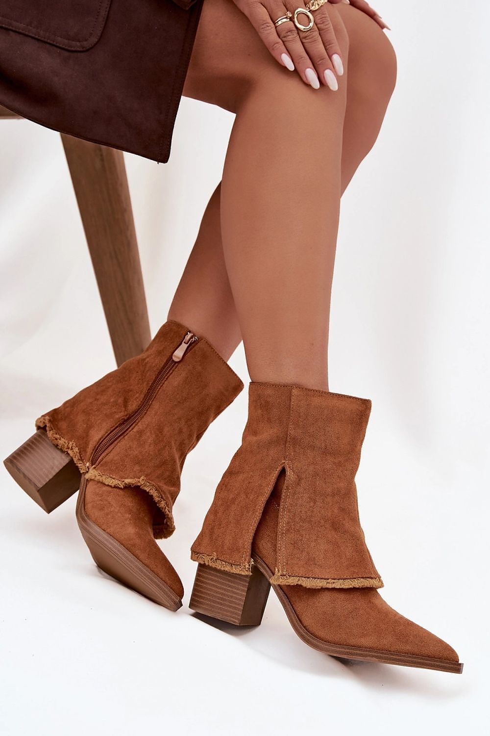 Side view of dark brown eco-suede ankle boots showing pointed toes