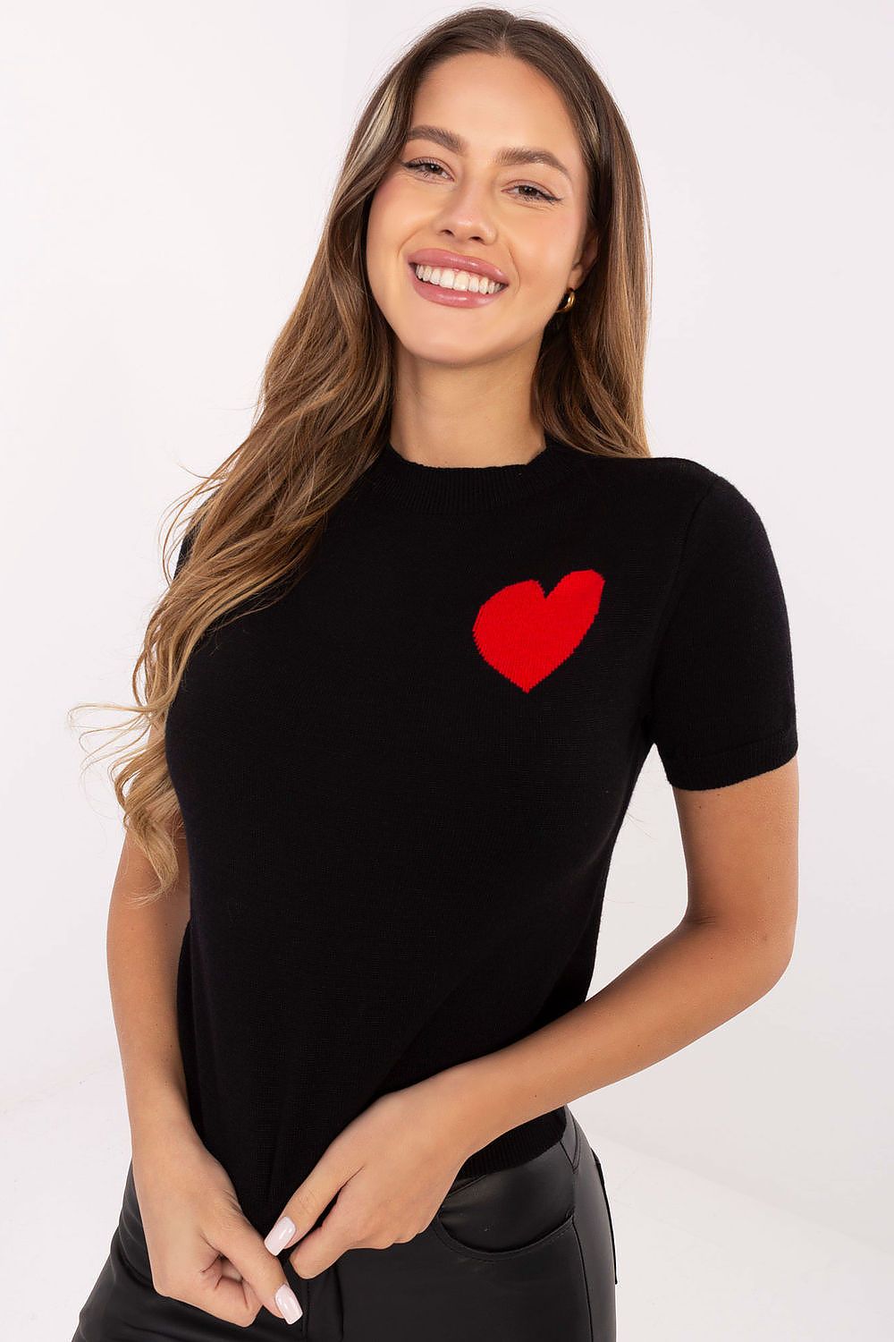 Black short sleeve sweater with contrasting heart print on chest.