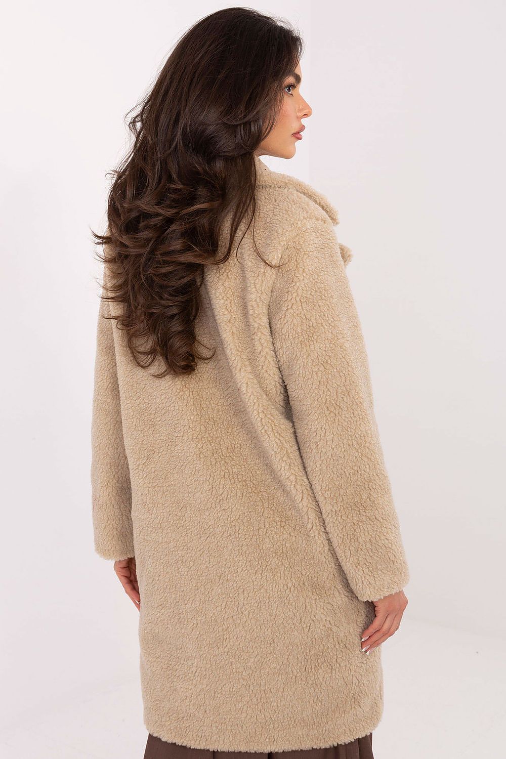 Woman wearing a beige coat on a white background