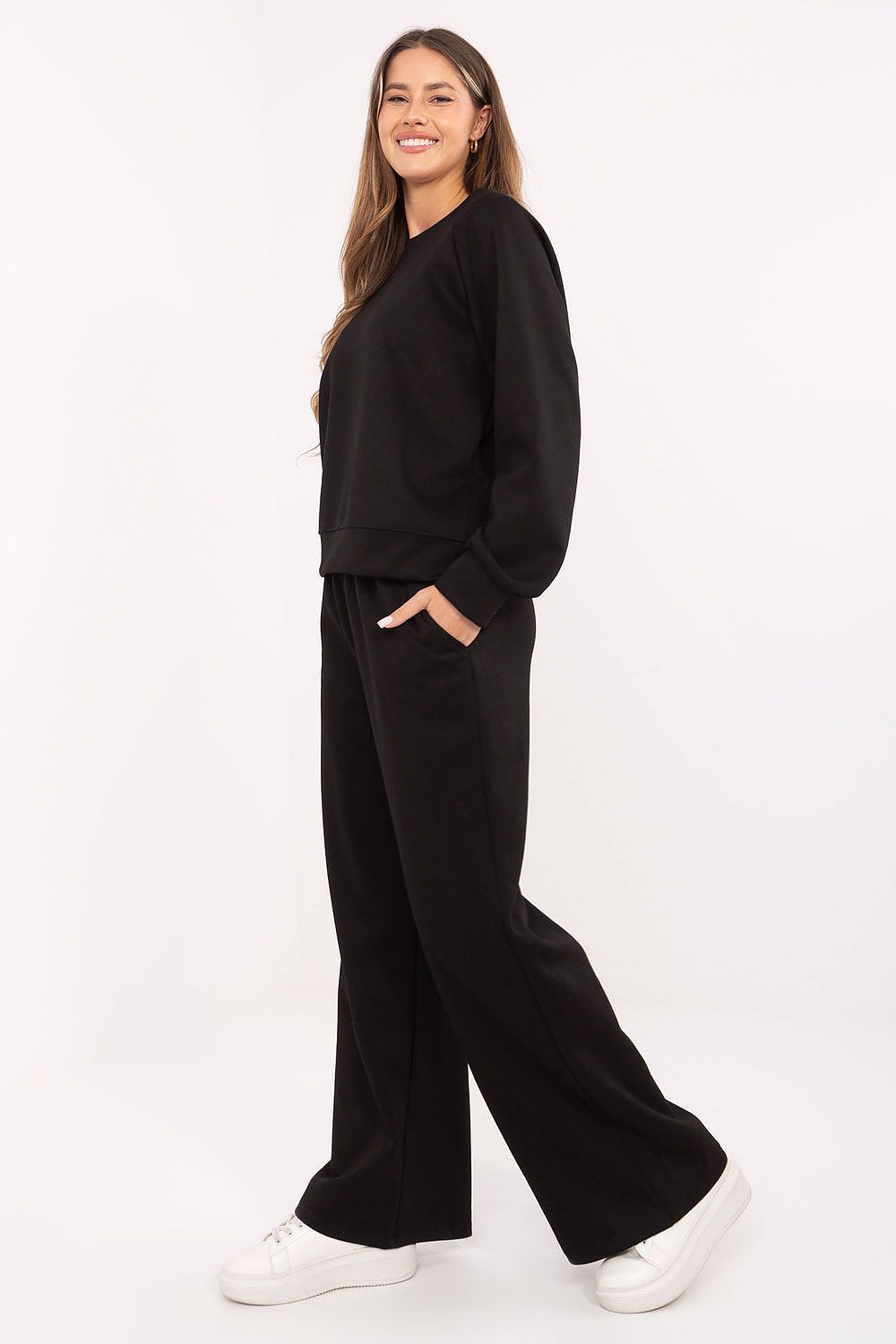 Woman wearing a black outfit on a white background