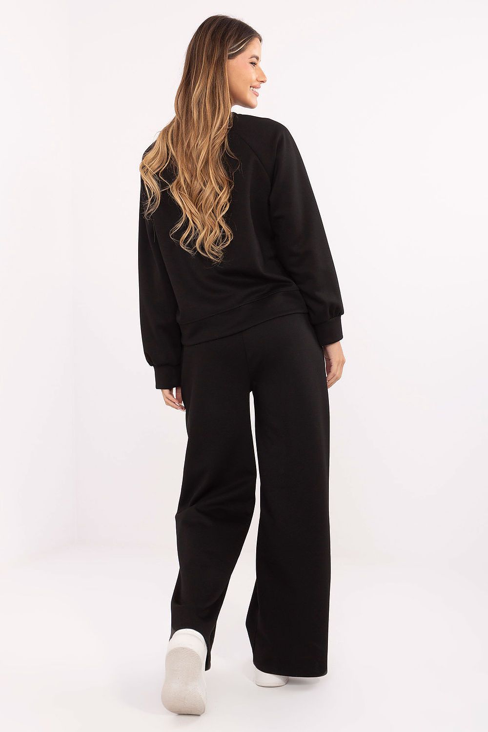 Woman wearing a black outfit on a white background