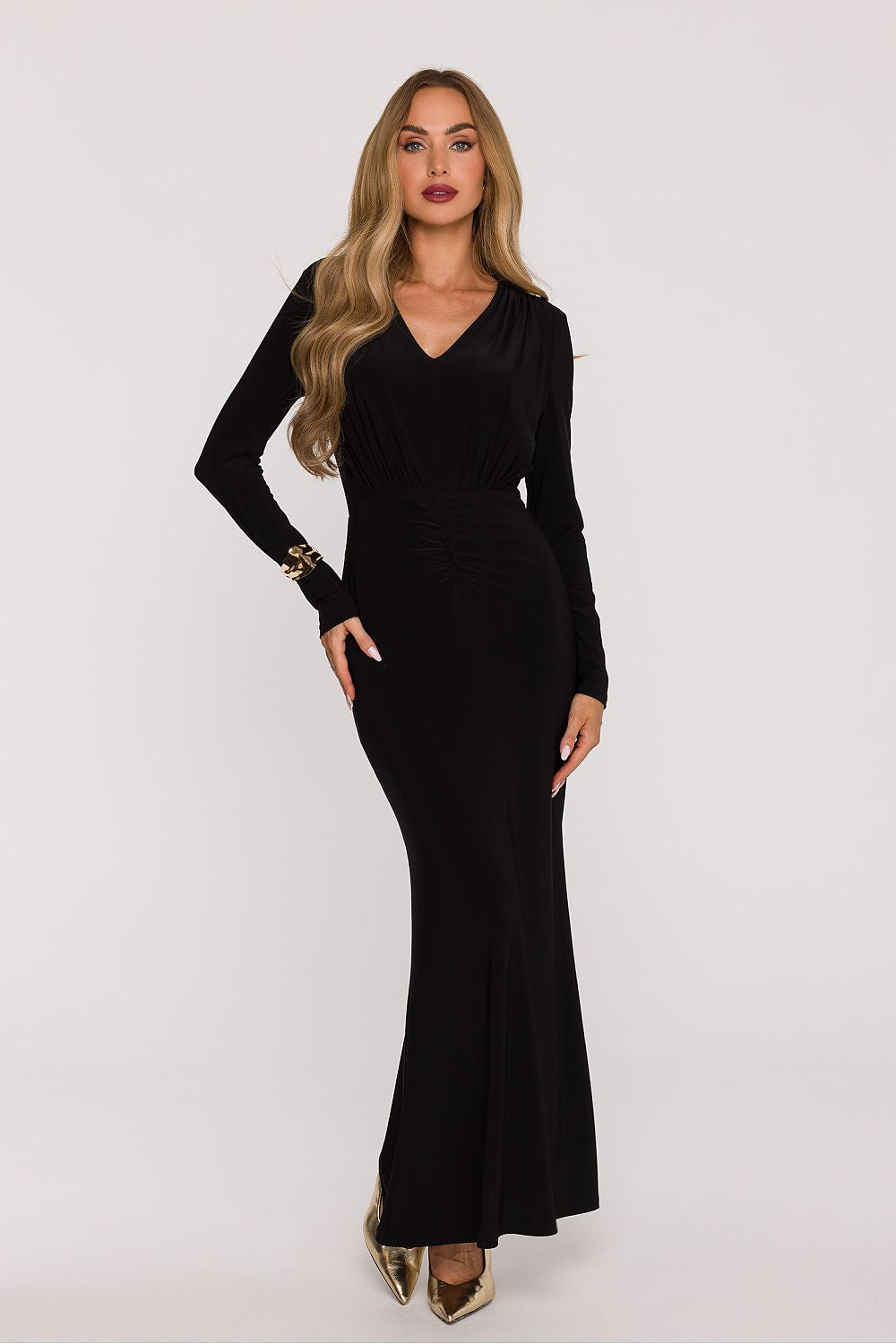 Woman wearing a black long-sleeve dress on a white background