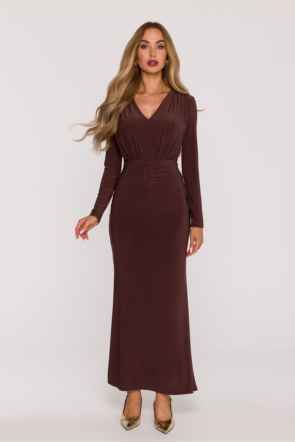 Woman wearing a brown long-sleeve dress on a white background