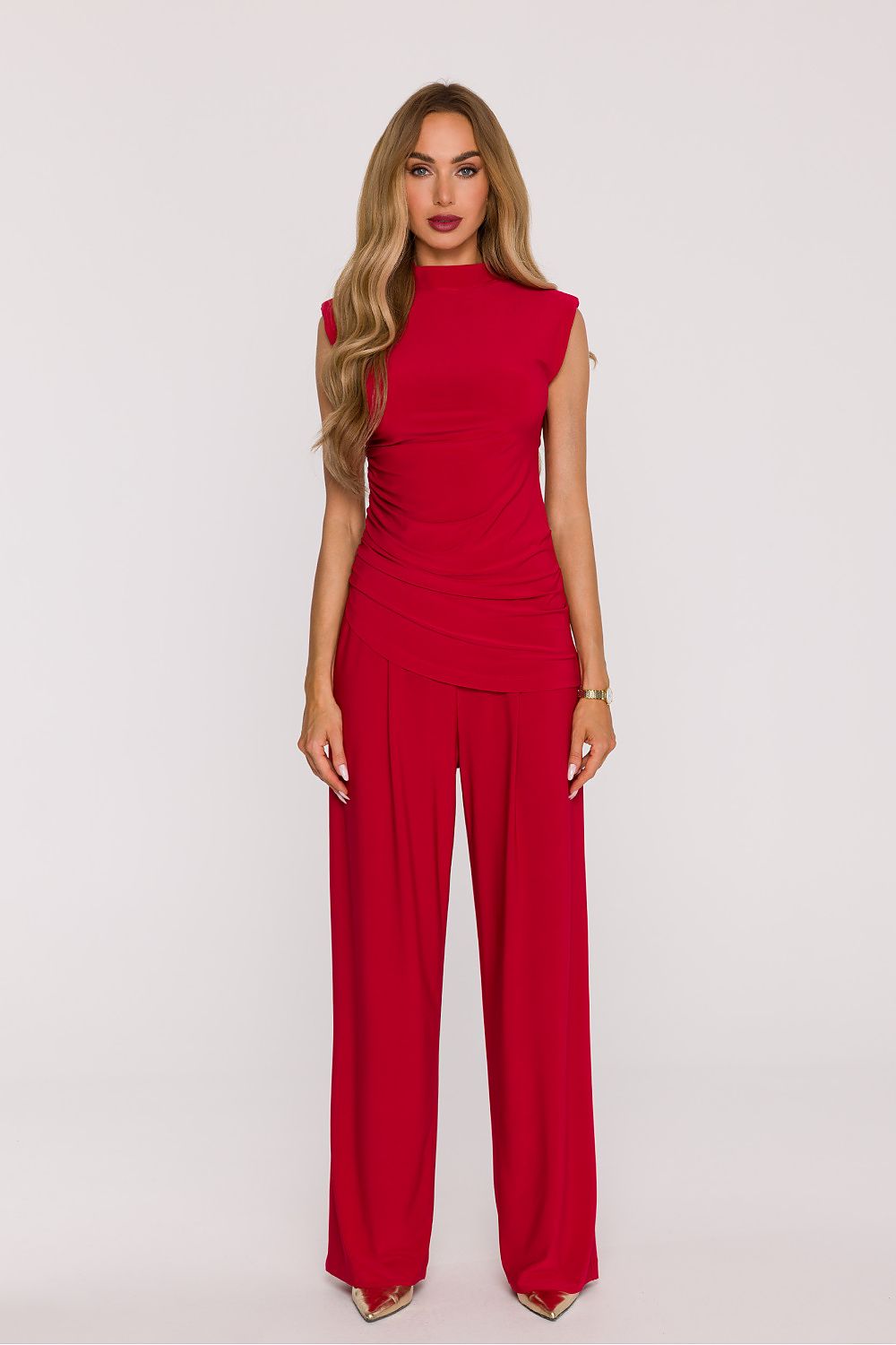 Woman wearing a red jumpsuit on a white background