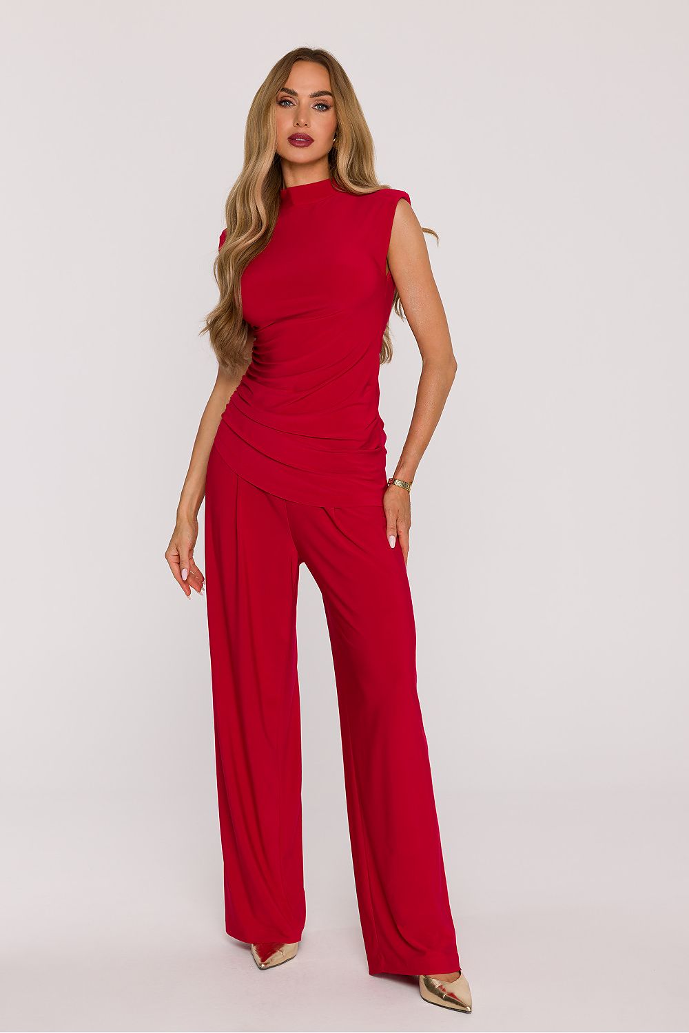 Woman wearing a red jumpsuit on a white background