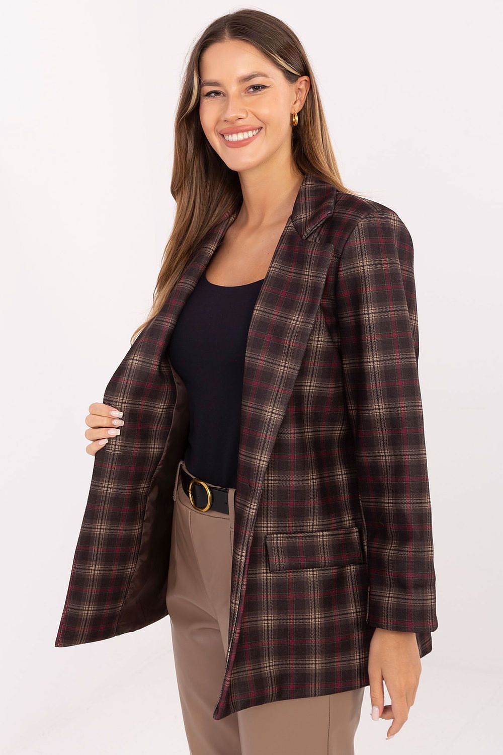 Close-up of checkered pattern and button detail on women’s blazer.