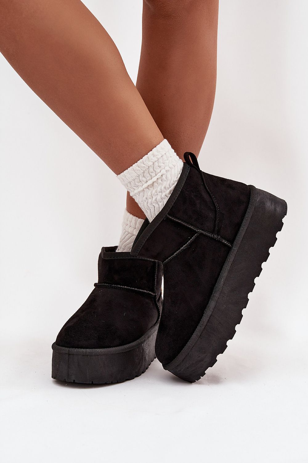  Side view of warm faux suede women’s snow boots showing soft fur interior and button detail in black