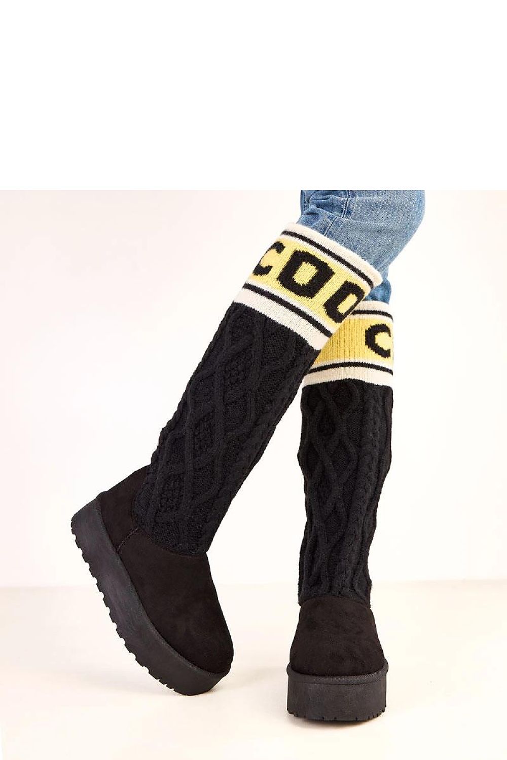 Black knee-high boots with yellow and white patterned cuffs on a white background