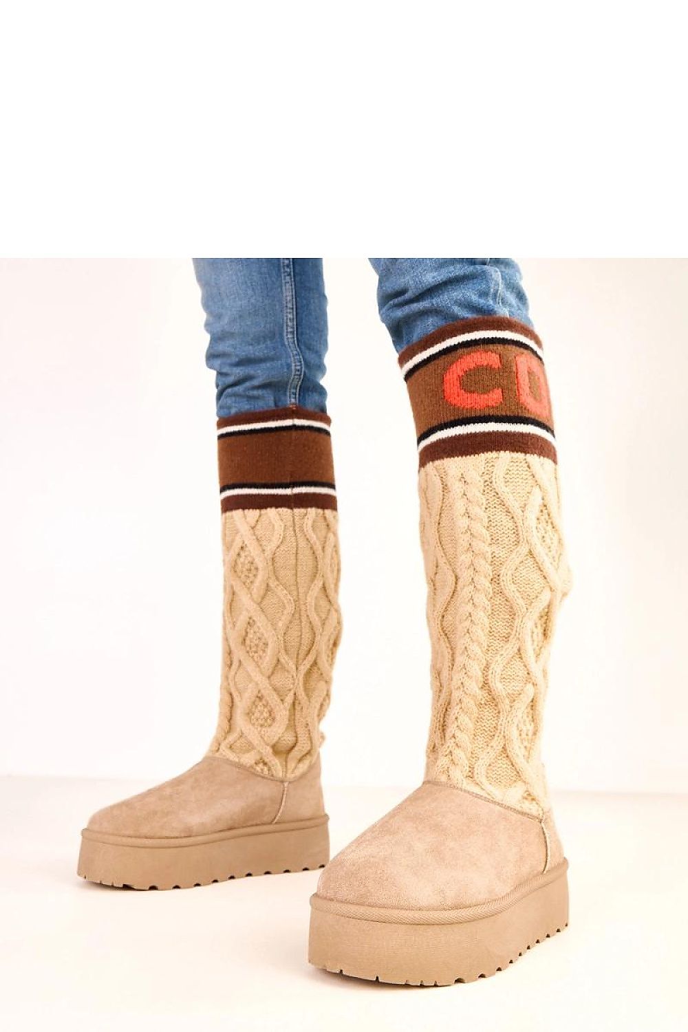 Beige platform boots with cable knit design and striped socks on a white background