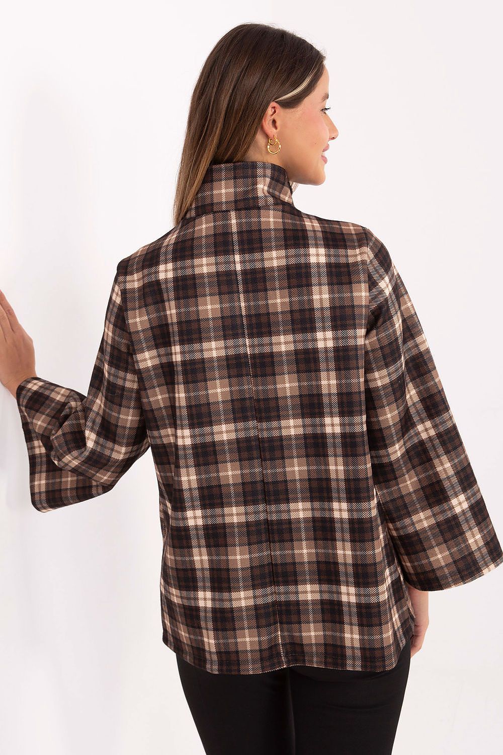 Woman wearing a plaid shirt with a white background