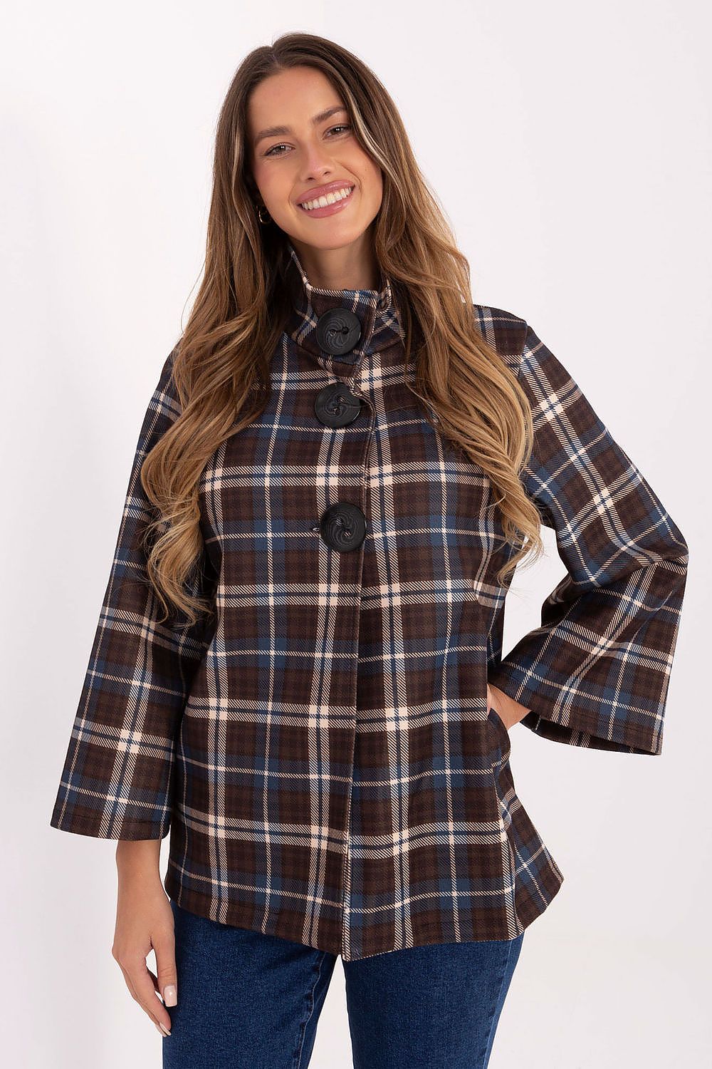 Woman wearing a plaid shirt with bell sleeves on a white background